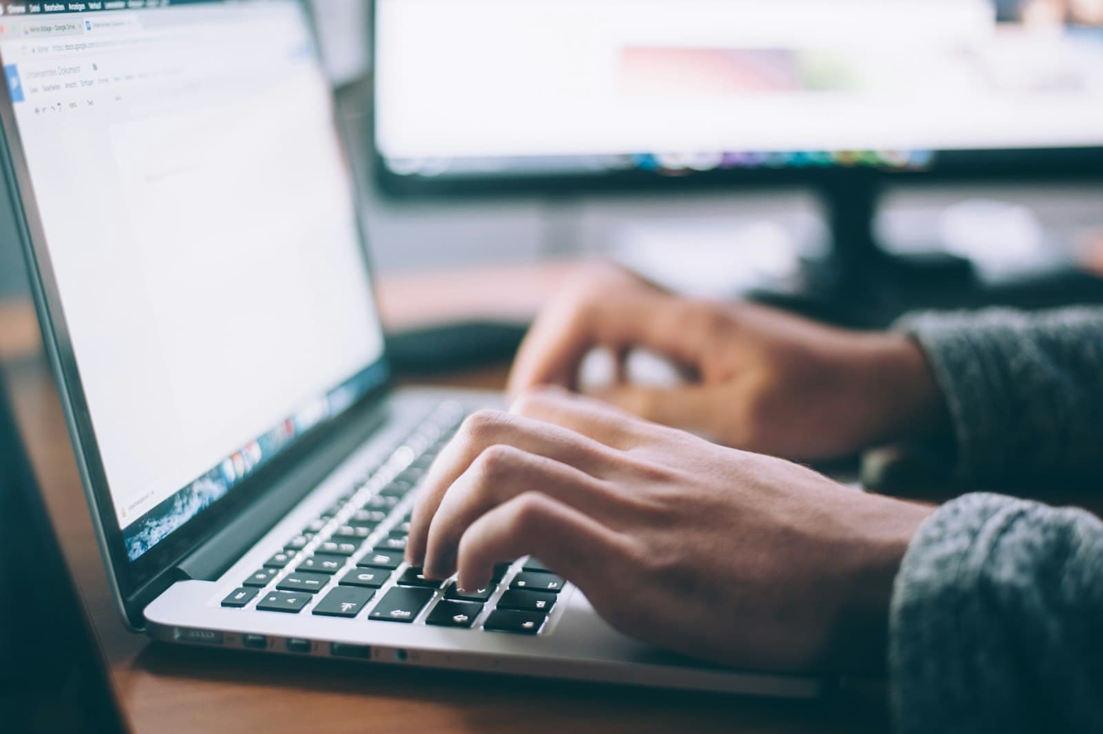 Person working at a laptop — Aroma Systems hero, not a data-center rack